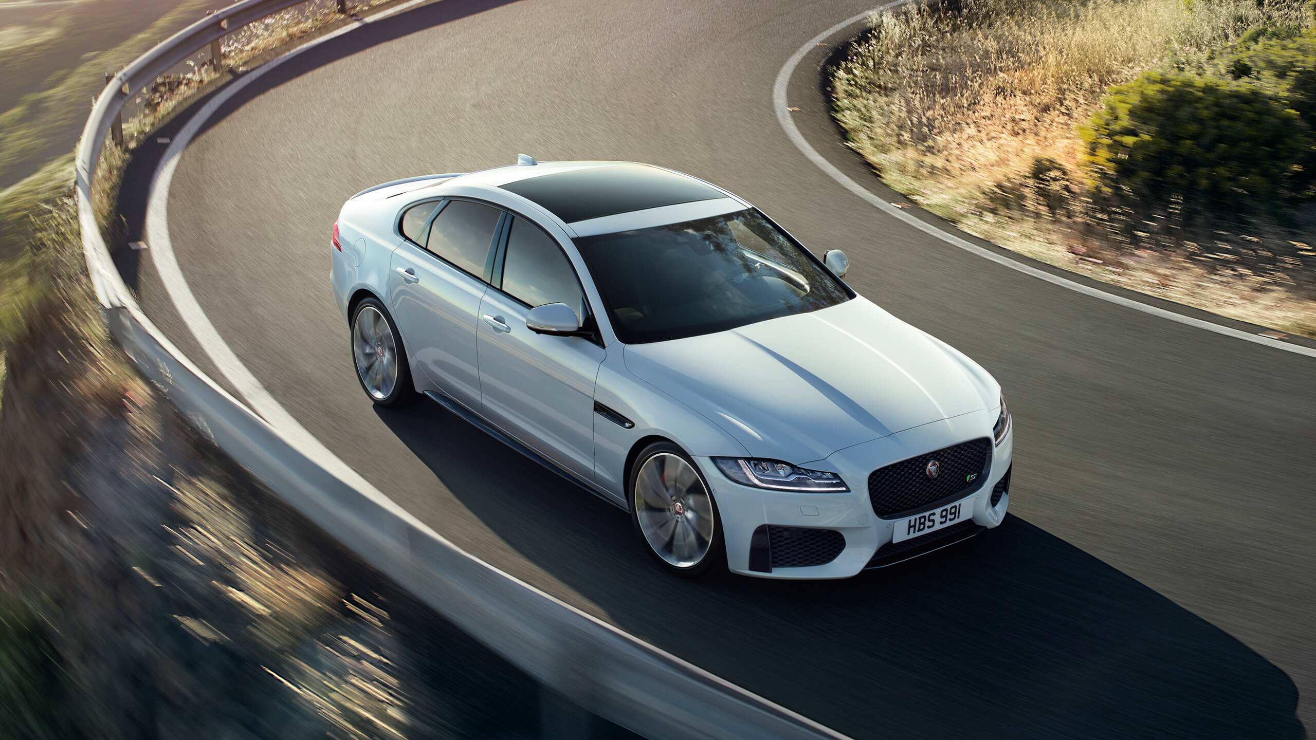 Jaguar XF model running on the hill road